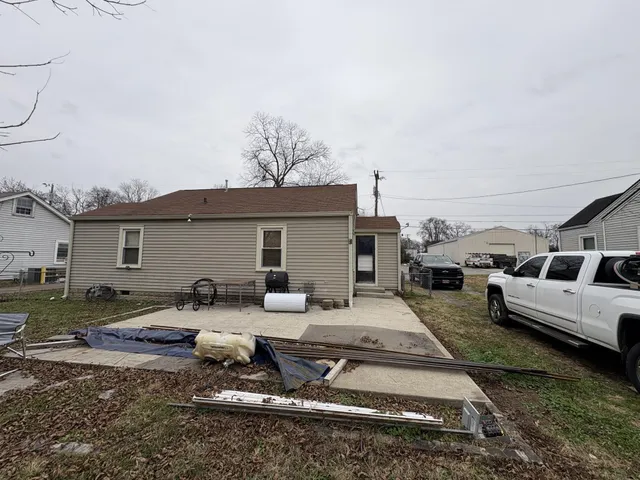 a backyard of a house with yard and outdoor seating