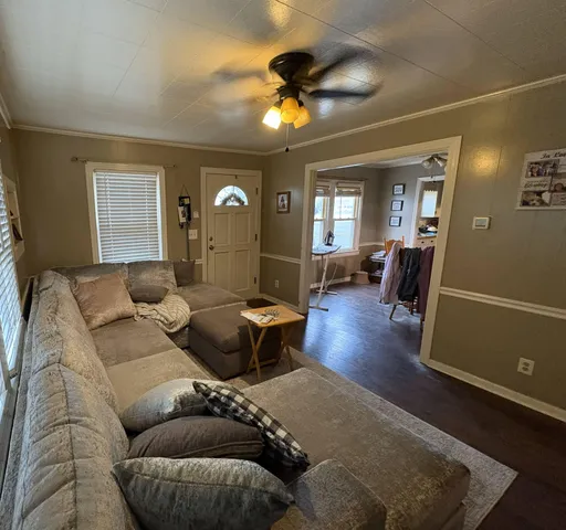 a living room with furniture and a chandelier