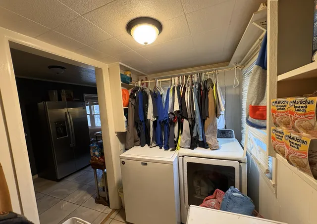 a view of a house with a yard and furniture