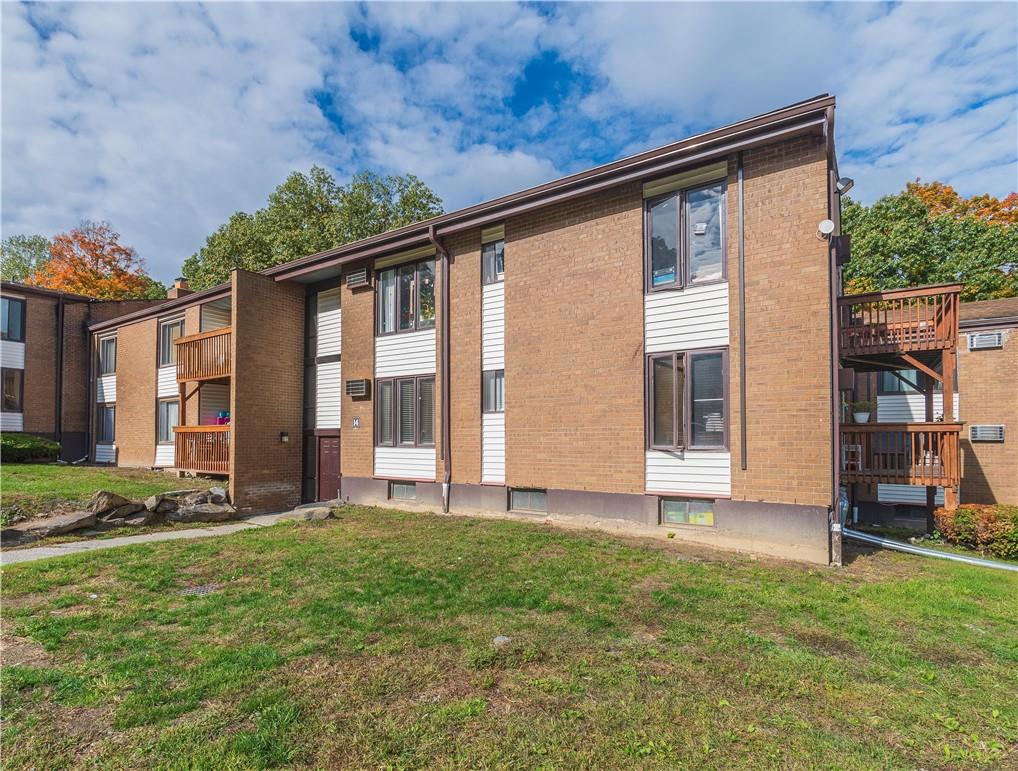 a view of a house with backyard and porch