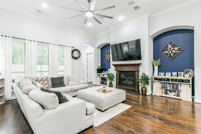 a living room with fireplace furniture and a flat screen tv