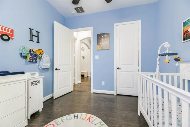 a hallway with cabinets and wooden floor
