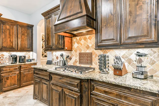 a kitchen with granite countertop stainless steel appliances a sink and cabinets