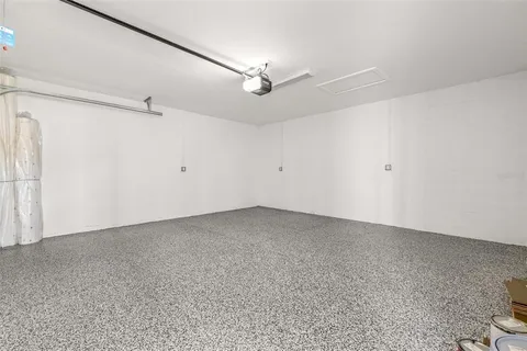 an empty room with a ceiling fan and a window