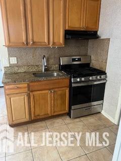 331 Watson Avenue, Unit 1 Perth Amboy, NJ 08861 - Photo 3 of 4 a kitchen with stainless steel appliances granite countertop a stove a sink and a microwave