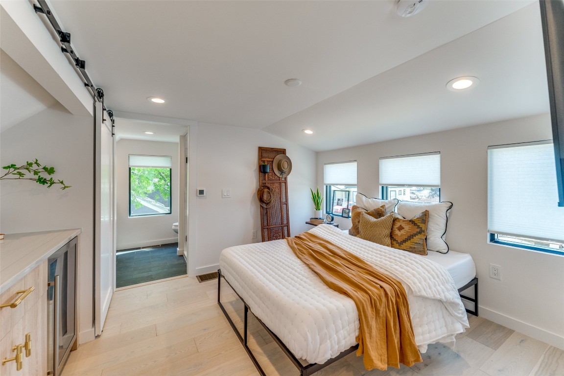 1901 Hamilton Avenue Austin, TX 78702 - Photo 24 of 28 a bedroom with a large bed and a chandelier