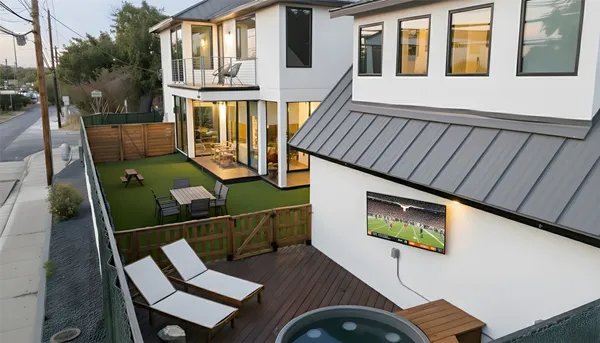 a backyard of a house with table and chairs