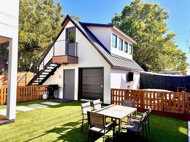 a view of a porch with furniture and a yard