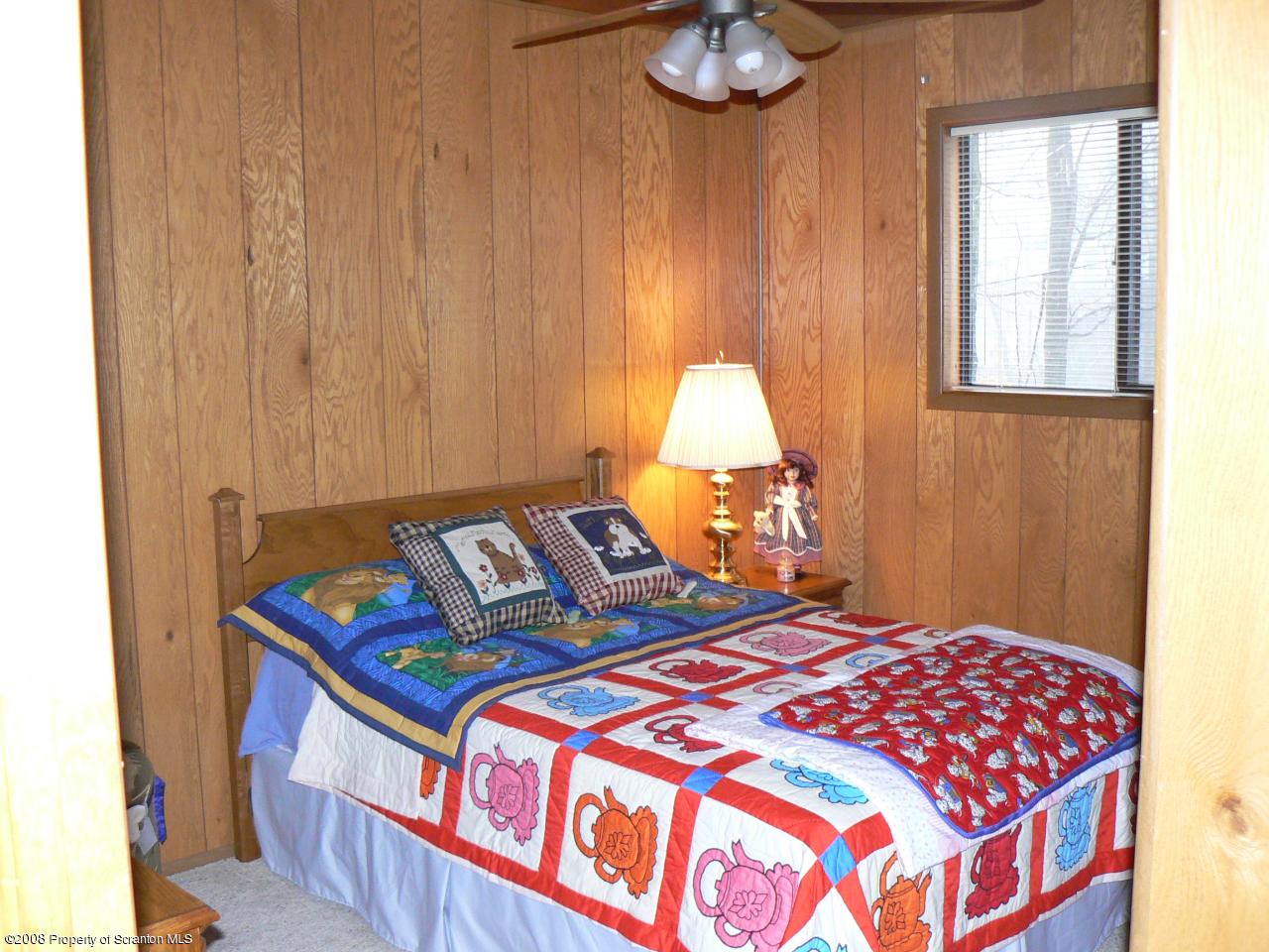 3198 Northgate Road Lake Ariel, PA 18436 - Photo 9 of 17 a bedroom with a bed and a chandelier