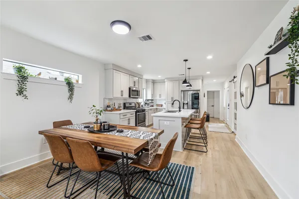 a dining room with furniture and wooden floor