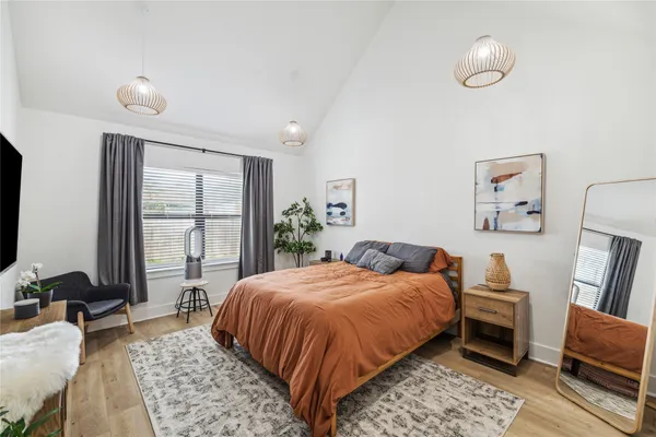 a bedroom with a large bed and a window