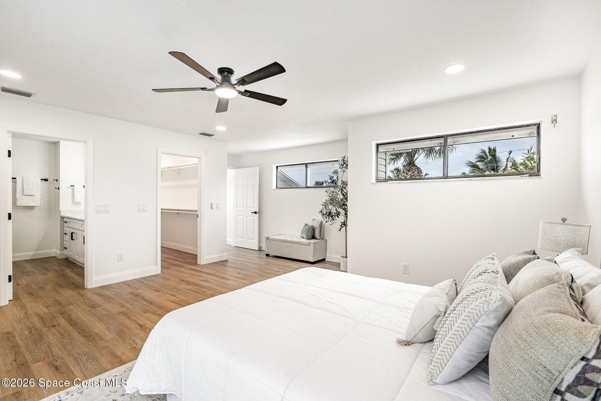 362 Nikomas Way Melbourne Beach, FL 32951 - Photo 13 of 32 a bedroom with a large bed and a chandelier