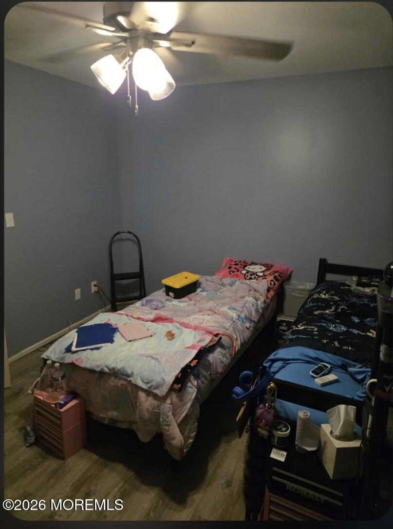 166 Sawmill Road, Unit 563 Brick, NJ 08724 - Photo 4 of 14 a bedroom with a bed and a chandelier