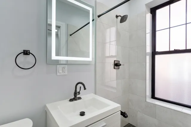 a bathroom with a sink toilet and shower