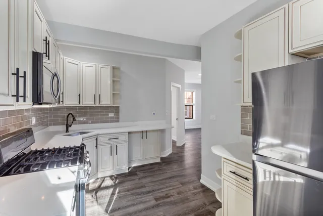 a bathroom with a double vanity sink a mirror and a shower