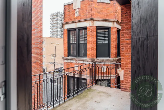 a view of a brick house with large windows