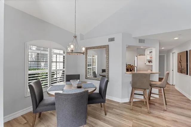 a bedroom with a bed next to a window with a bookshelf