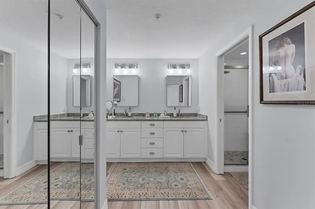 a bathroom with a granite countertop sink and a mirror