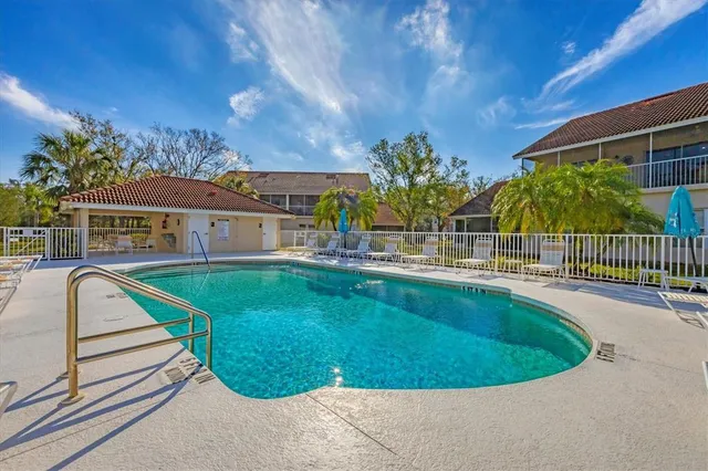an aerial view of residential houses with outdoor space and swimming pool