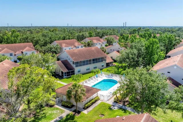 an aerial view of residential houses with outdoor space