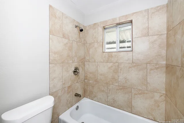 a bathroom with a toilet and shower