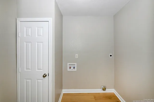 a view of a room with wooden floor