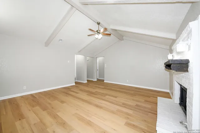 a view of empty room with ceiling fan