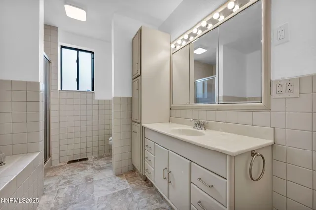 a patio with glass top table and chairs