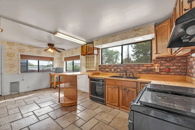 a kitchen with a stove a sink and a refrigerator