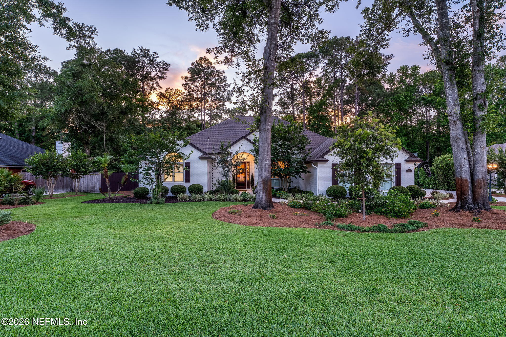 1204 Creek Bend Road St. Johns, FL 32259 - Photo 3 of 107 a front view of a house with a big yard and a large tree