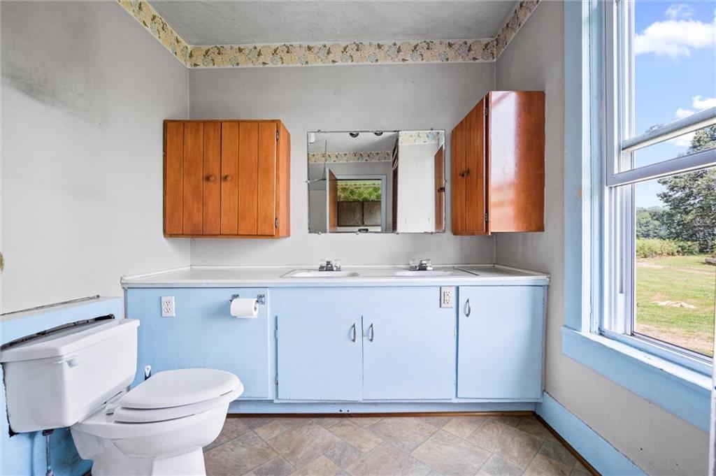 2789 Rutledge Road Transfer, PA 16154 - Photo 12 of 50 a bathroom with a toilet sink and mirror