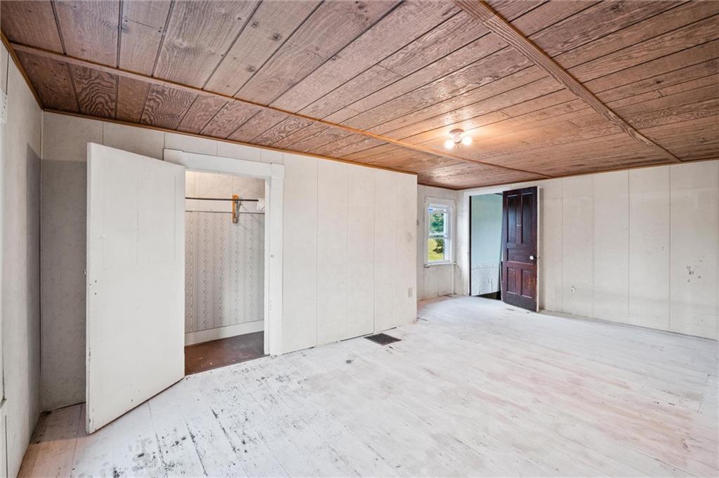 2789 Rutledge Road Transfer, PA 16154 - Photo 15 of 50 a view of a bedroom with a bed and wooden floor