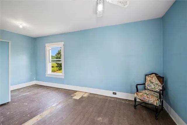 a view of room with window and wooden floor