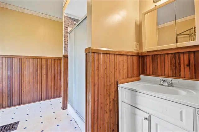 a bathroom with a sink a mirror and a shower curtain