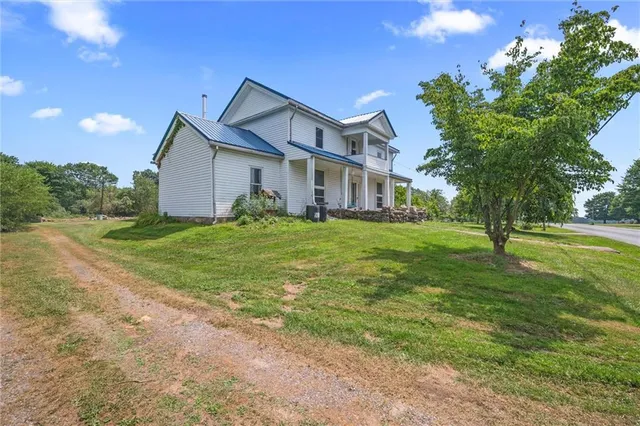a big house with a big yard and large trees