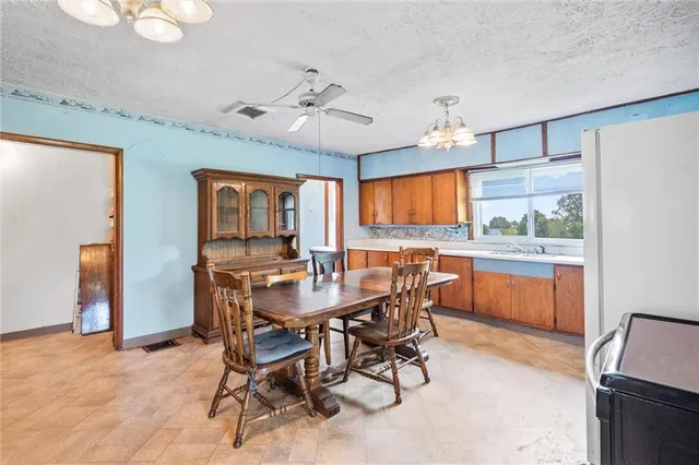 a view of a dining room with furniture and chandelier