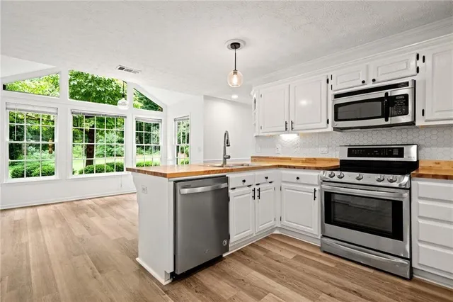 a kitchen with stainless steel appliances granite countertop a stove and a sink
