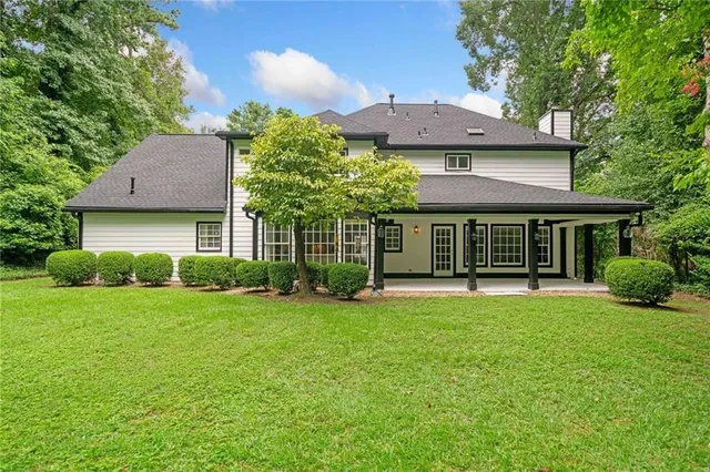 a view of a house with a yard and plants