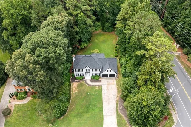 an aerial view of a house with yard swimming pool and outdoor seating