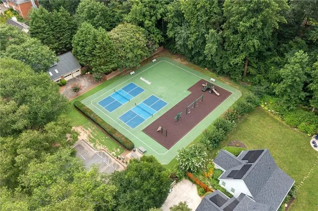 an aerial view of a tennis ground and a yard