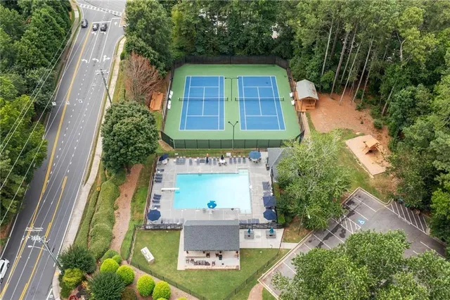 an aerial view of a house with swimming pool garden and patio