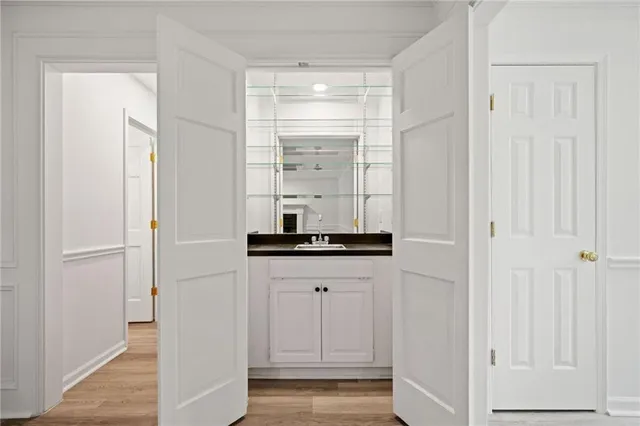 a room with white cabinets and a sink