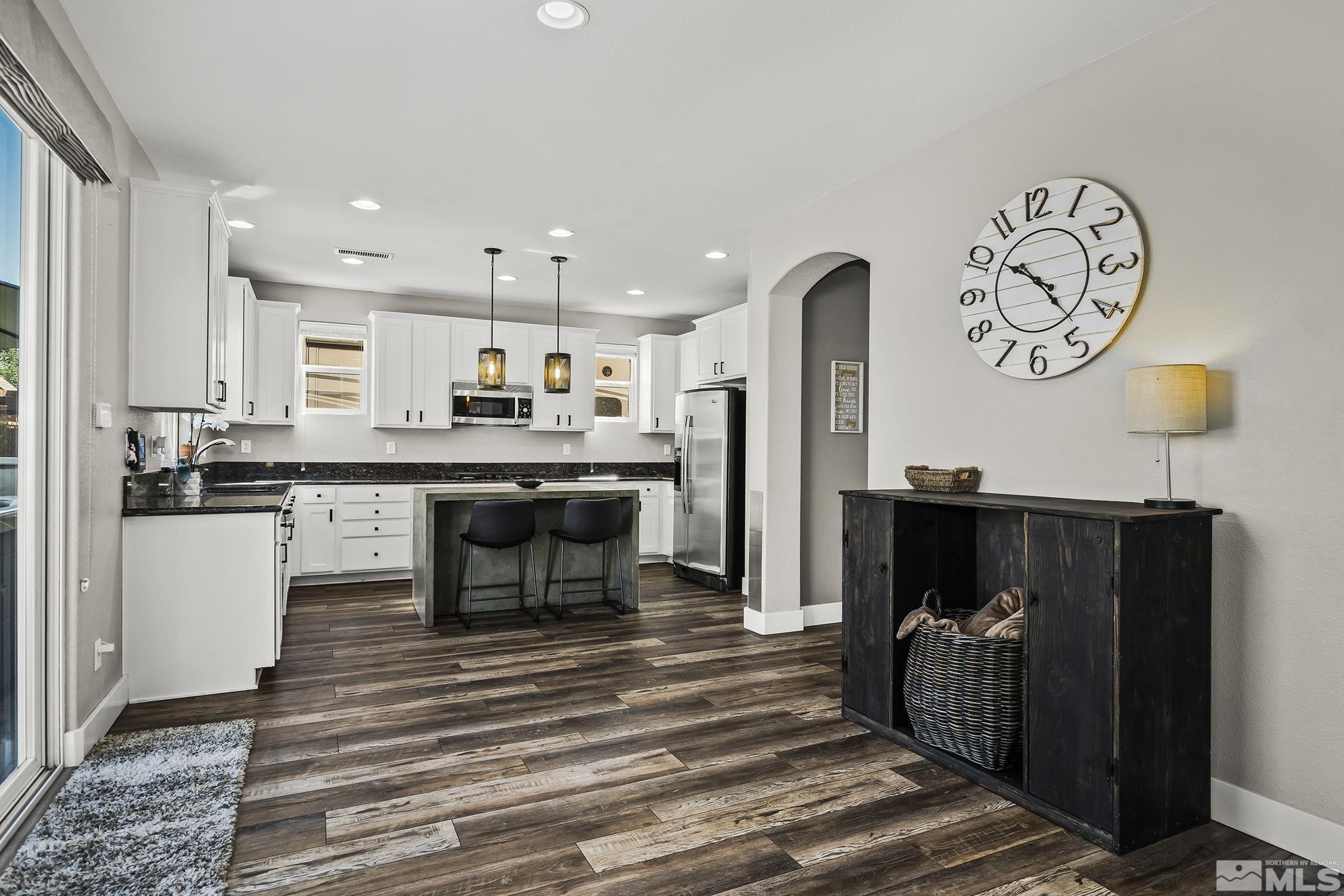 375 Sondrio Way Reno, NV 89521 - Photo 15 of 36 a kitchen with stainless steel appliances granite countertop a refrigerator a stove and a cabinets