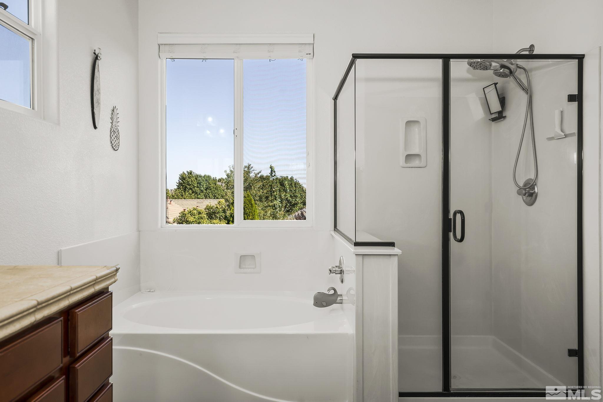 375 Sondrio Way Reno, NV 89521 - Photo 23 of 36 a bathroom with a bathtub and a shower
