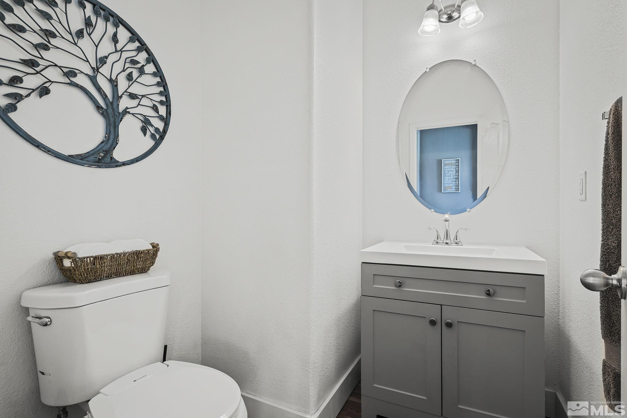 375 Sondrio Way Reno, NV 89521 - Photo 27 of 36 a bathroom with a toilet a sink and a mirror