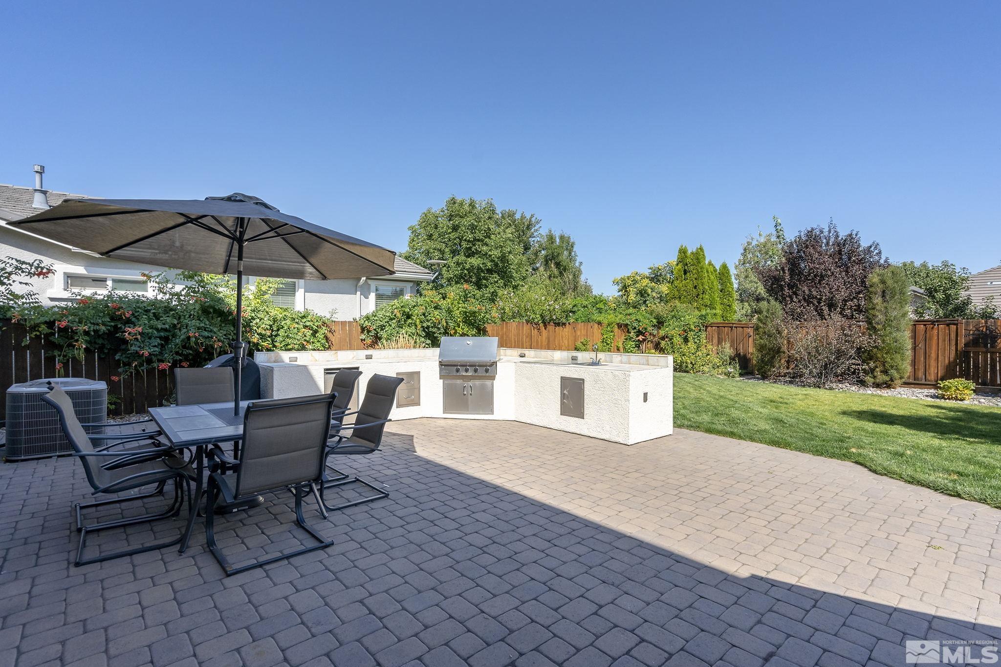 375 Sondrio Way Reno, NV 89521 - Photo 28 of 36 a view of a patio with a table and chairs under an umbrella