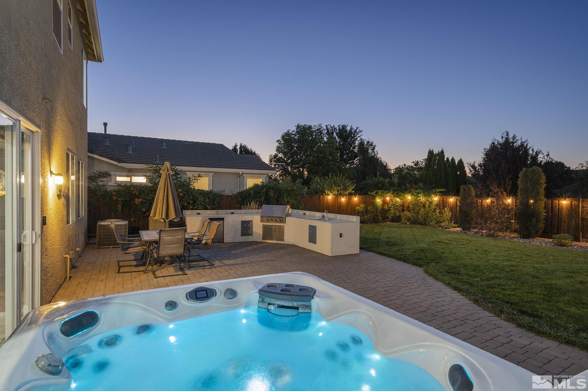 375 Sondrio Way Reno, NV 89521 - Photo 3 of 36 a view of a patio with couches and table and chairs under an umbrella