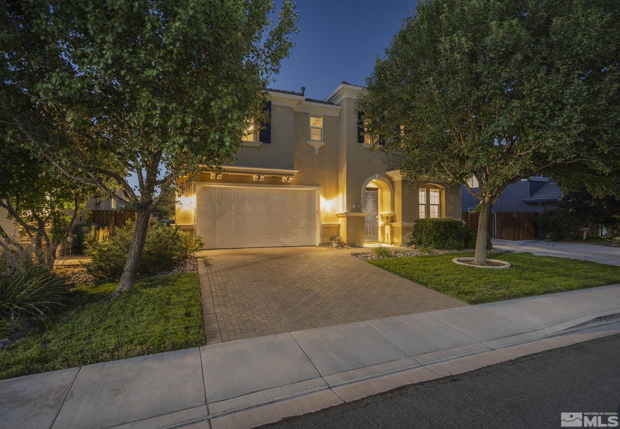 375 Sondrio Way Reno, NV 89521 - Photo 35 of 36 a front view of a house with a yard and garage