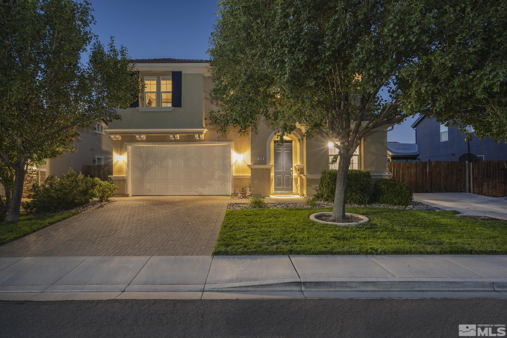 375 Sondrio Way Reno, NV 89521 - Photo 6 of 36 a front view of a house with a yard and a garage