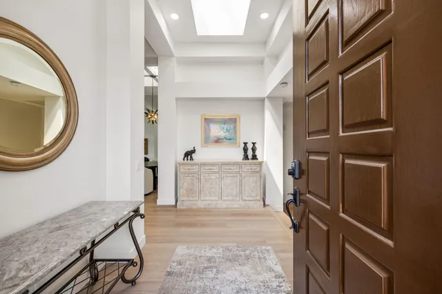 a living room with furniture a ceiling fan and a rug